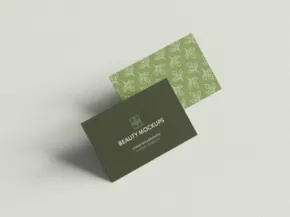 Two business cards with green patterns and white text presented on a mockup template with a light gray background. - PSD Mockup