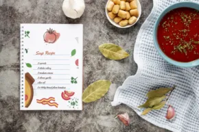 Soup recipe template on a clipboard with ingredients and a bowl of soup nearby. - PSD Mockup