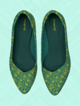 A pair of teal and yellow patterned women's flats against a light teal background with a subtle geometric template. - PSD Mockup