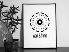 Black and white framed graphic print with an eye design beside a potted succulent on a shelf, serving as a perfect mockup template. - PSD Mockup