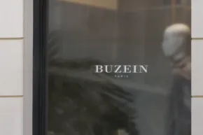 A blurred window display with a mannequin and the text "buzein" visible, serving as a template. - PSD Mockup