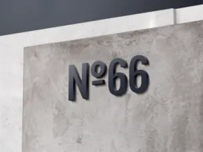 A concrete wall displays the text "N°66" in dark, three-dimensional lettering, serving as a striking template for design inspiration. - PSD Mockup