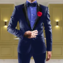 Man in a blue tuxedo with a red boutonniere standing indoors, serving as a template. - PSD Mockup
