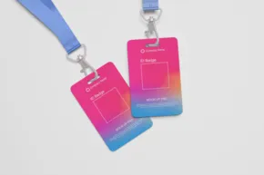 Two colorful badge id templates with blue lanyards on a white background. - PSD Mockup