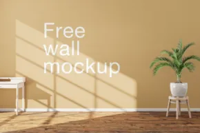 A room with plain walls featuring the text "free wall mockup," a small table with a plant in a white vase, and soft shadows cast by a window. - PSD Mockup