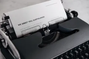Vintage typewriter with a template sheet of paper titled "we great one generation. - PSD Mockup