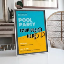 A template for a pool party poster on a display stand in a modern room setting, with placeholders for design details. - PSD Mockup