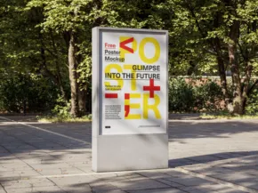 Outdoor advertising kiosk displaying a colorful mockup template with large text and symbols, surrounded by trees in a sunny park setting. - PSD Mockup