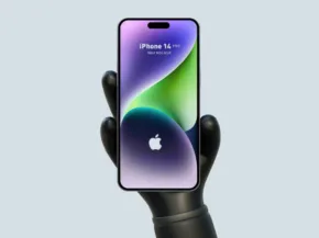 A robotic hand holding an iPhone 14 mockup, displaying a colorful curved line design on its screen against a light grey background. - PSD Mockup