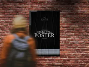 A person with a backpack walking past a mockup poster on a brick wall. - PSD Mockup