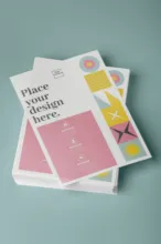 A mockup stack of brochures on a blue background. - PSD Mockup