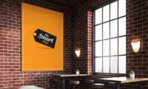 A spacious room with brick walls and large windows, featuring a yellow banner with "golden ticket" printed on a black mockup, hanging on the wall. - PSD Mockup