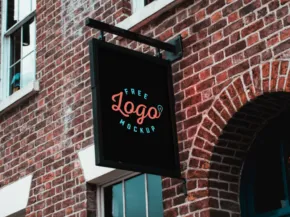 A black square storefront sign with a generic "template" design against a brick building facade. - PSD Mockup