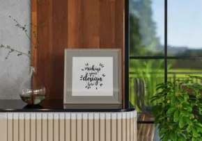 Inspirational quote mockup on a wooden shelf with a green outdoor view in the background. - PSD Mockup
