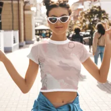 A woman wearing sunglasses and a pink crop top in a mockup. - PSD Mockup