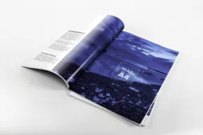 Open magazine template displaying blue-toned imagery on a white surface. - PSD Mockup