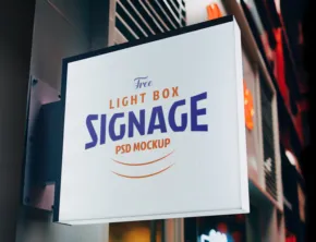 A lightbox sign hanging outdoor with the text "the light box signage pro group" displayed in a stylish font and offered as a template. - PSD Mockup