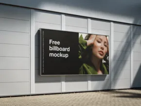 Billboard on a building exterior displaying a template featuring a woman with her hand on her face. The text "free billboard mockup" is visible. - PSD Mockup