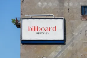 A mockup of a billboard mounted on a building wall with the word "billboard" in lowercase letters on a white background. - PSD Mockup