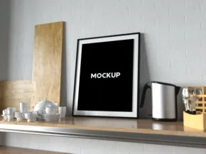 A sleek kitchen shelf displaying a mockup template, a steel jug, and glasses next to a wooden chopping board. - PSD Mockup
