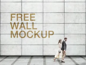 A man and a woman walking past a large wall with the text "free wall template" displayed on it. - PSD Mockup