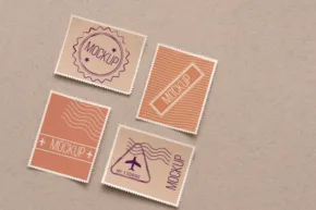 Four assorted stamp templates with different designs on a beige surface. - PSD Mockup
