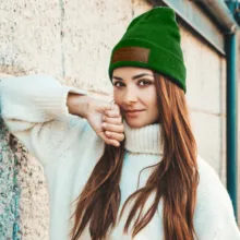 A woman in a white sweater and green hat mockup. - PSD Mockup