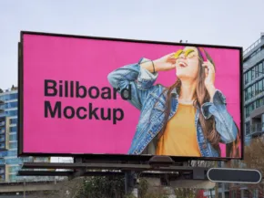 A large billboard featuring a mockup ad with a young woman in a denim jacket enjoying music through headphones, set against a pink background. - PSD Mockup