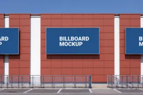 Three large billboard templates on a red and white building facade above an empty parking lot. - PSD Mockup