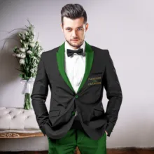 Man in a stylish green suit with a black lapel and bow tie posing confidently as a mockup. - PSD Mockup