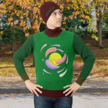 Man in a green sweater and beanie standing with hands on hips outdoors in autumn, perfect for a mockup template. - PSD Mockup