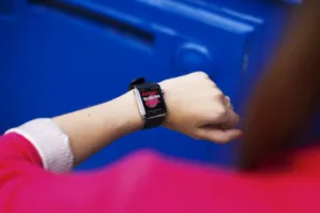 A woman's wrist with a smart watch mockup. - PSD Mockup