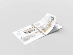 A curved magazine template displaying interior design layouts on a plain, light gray background. - PSD Mockup