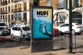 Outdoor advertisement template on a mupi kiosk featuring a scene of a whale tail at sea, placed at a busy street intersection. - PSD Mockup