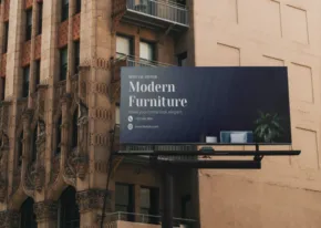 A mockup of a billboard advertisement for modern furniture mounted on the exterior of a building. - PSD Mockup