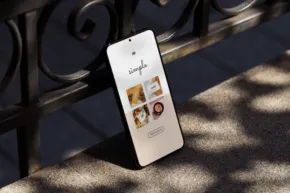 A smartphone displaying a food delivery app template, resting on a stone ledge in dappled sunlight. - PSD Mockup
