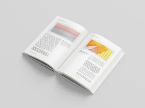 Open magazine with colorful graphic pages on a gray background, serving as an ideal mockup. - PSD Mockup