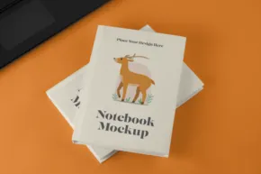 A notebook mockup with a deer template on it. - PSD Mockup