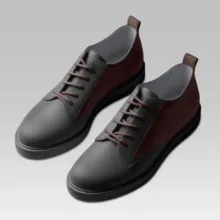 A pair of stylish two-toned shoes with dark gray fronts and burgundy backs, featuring brown laces on a light gray template. - PSD Mockup