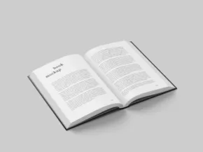 Open book template with visible text on a plain gray background. - PSD Mockup