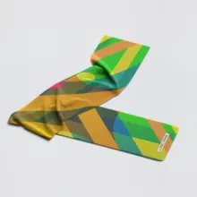 Colorful geometric-patterned scarf mockup lying flat on a light gray background. - PSD Mockup