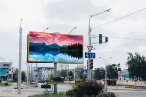 A large digital billboard mockup in the middle of a street. - PSD Mockup