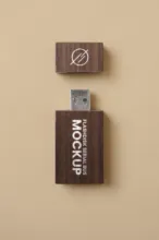 A wooden USB flash drive with a cap, featuring a template on the top part and the word "mockup" on the lower part, against a beige background. - PSD Mockup