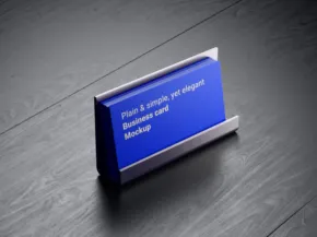 A blue desk nameplate on a wooden surface displaying the text "paul s. leigh, phd, project director, gentek," serves as a template mockup. - PSD Mockup