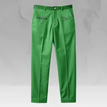 Green trousers with a black belt, displayed against a gray marbled background in a mockup. The trousers feature cursive embroidery near the waistband. - PSD Mockup