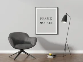 A minimalistic room with a gray chair, floor lamp, and a framed poster on the wall, all against a plain gray mockup background. - PSD Mockup