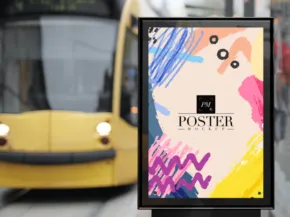 A colorful abstract poster mockup displayed on a billboard with a yellow tram in the background. - PSD Mockup