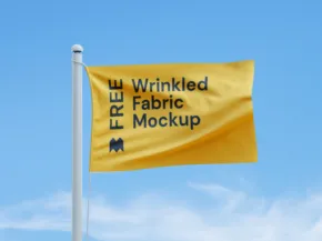 Yellow flag with the template "free wrinkled fabric mockup" fluttering on a flagpole against a clear blue sky. - PSD Mockup