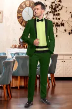 A man in a green suit with a black shirt and green bow tie standing in an elegant room with vintage decor, serving as a perfect template. - PSD Mockup