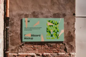 A mural titled "reconnect" by Richard Mockup, displayed on a brick wall, featuring abstract geometric shapes in green and beige. - PSD Mockup